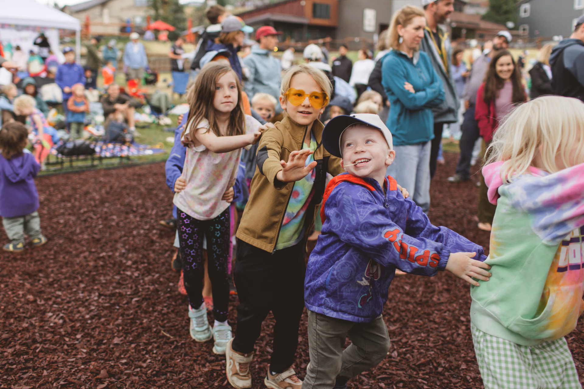 Children dance in a conga line
