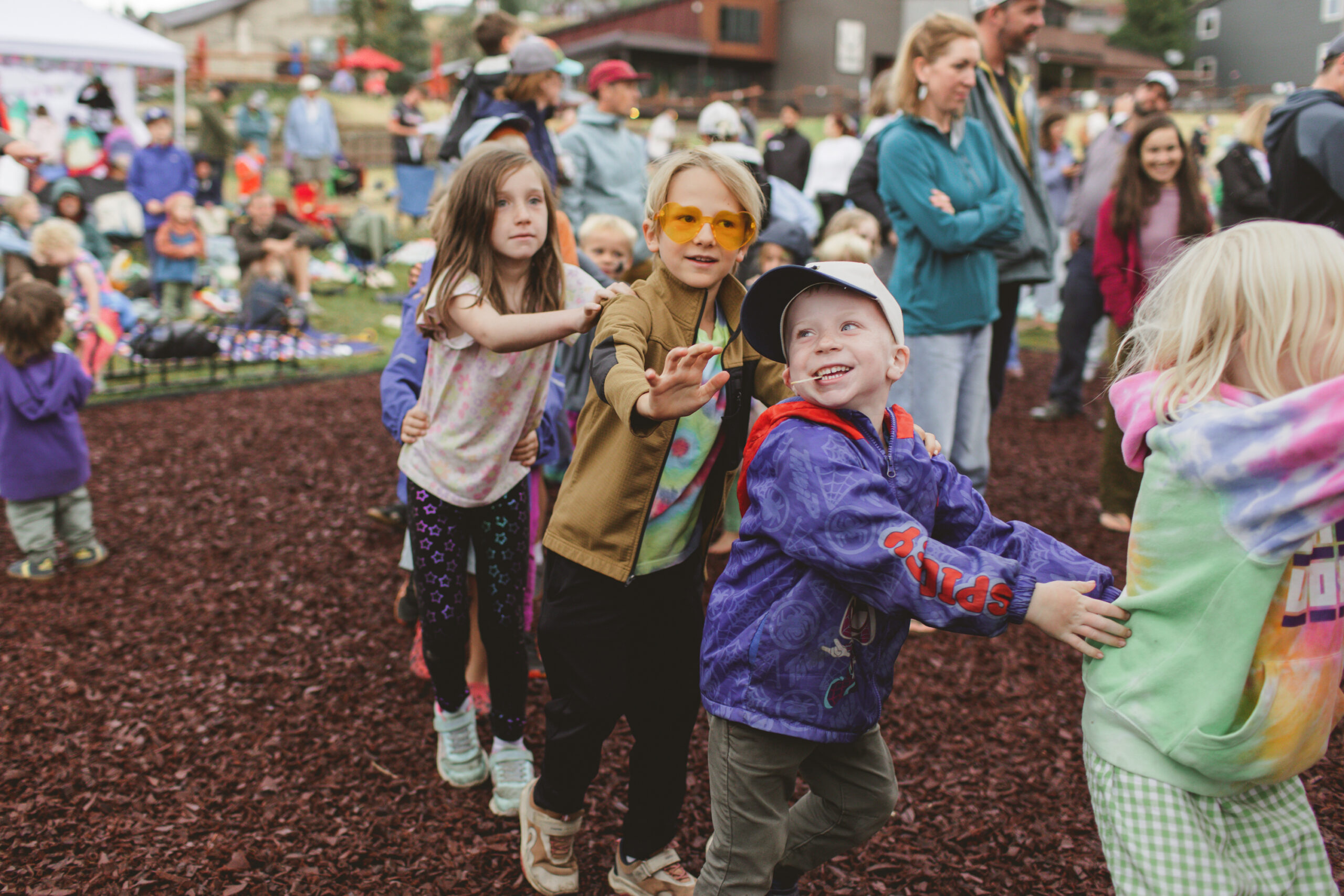 Children dance in a conga line